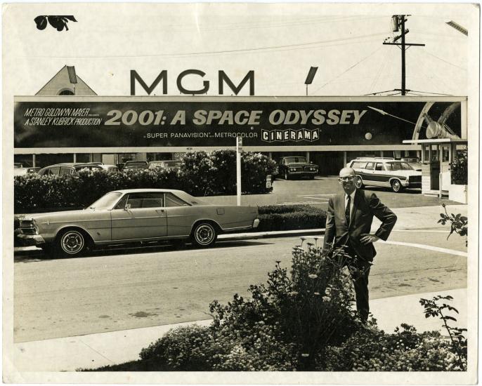 Arthur C. Clarke poses for a photo beneath a sign advertising the motion picture "2001: A Space Odyssey," May 16, 1968.