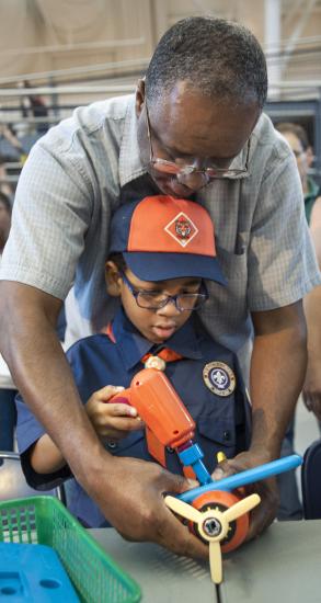 Father and son putting together an airplane model