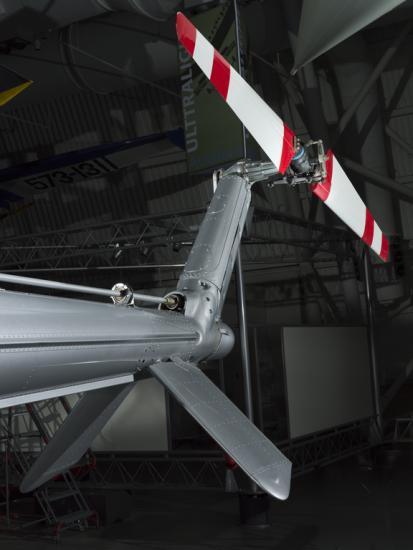 View of a red and white painted tail rotor on a helicopter.