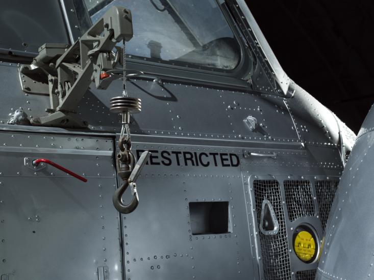 Close up of an oil cap and cargo hook of a helicopter.