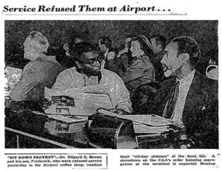 Newspaper clipping with black and white photo of two men sitting at a food counter. 