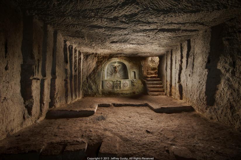 A trench with art carved into wall by artist soldiers.