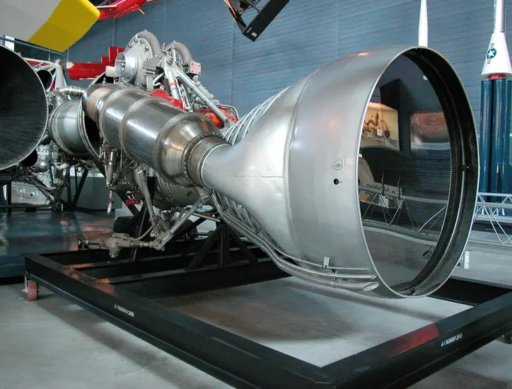 A metal contraption that is larger than a person with a huge bell opening at the end. 