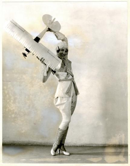 Woman posing with a model aircraft.