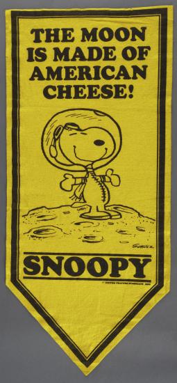 A yellow banner with Snoopy the dog wearing an astronaut helmet.