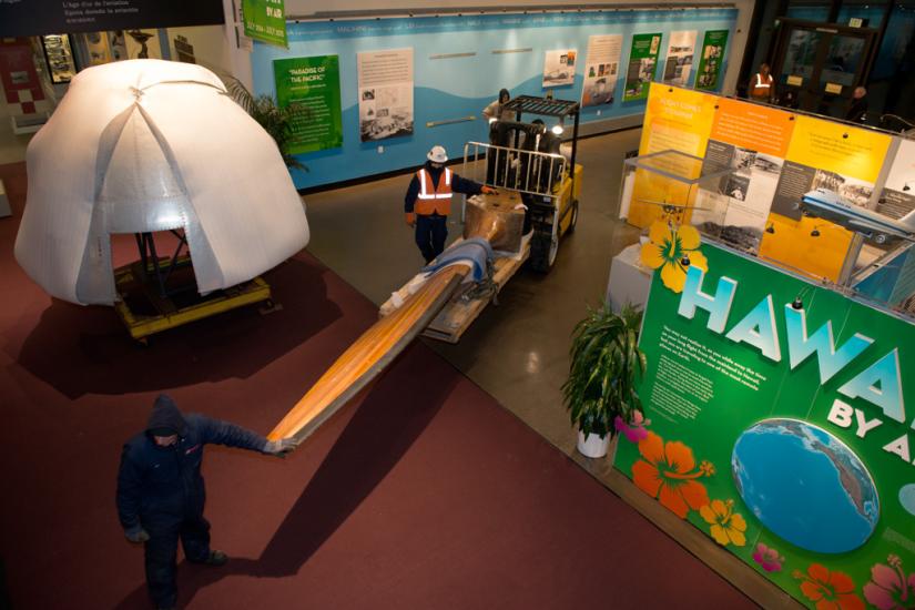 A trolley is used to transport a large wooden blade belonging to a wind tunnel fan in the Museum.