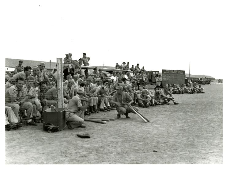 A large group of people view a baseball game played in India.