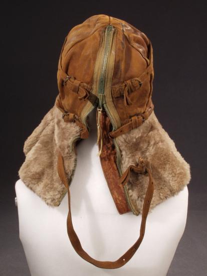 Back view of aviation helmet with leather faceguard and cap and brown fur collar protecting the neck. A full-length zipper and adjustment straps allow for a proper fit. Styled on mannequin.