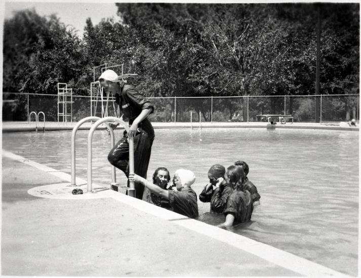 Female pilots-in-training in the process of exiting a swimming pool following a swimming lesson.