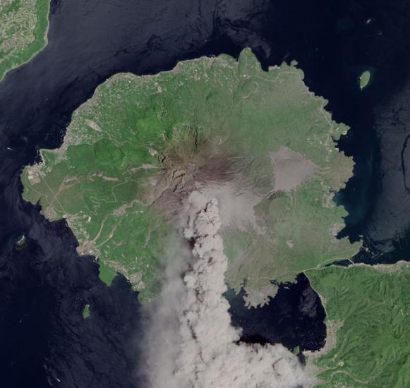 Satellite view of Sakura-jima, a volcano in Japan, during an eruption. Plumes of smoke are in the atmosphere above the volcano.