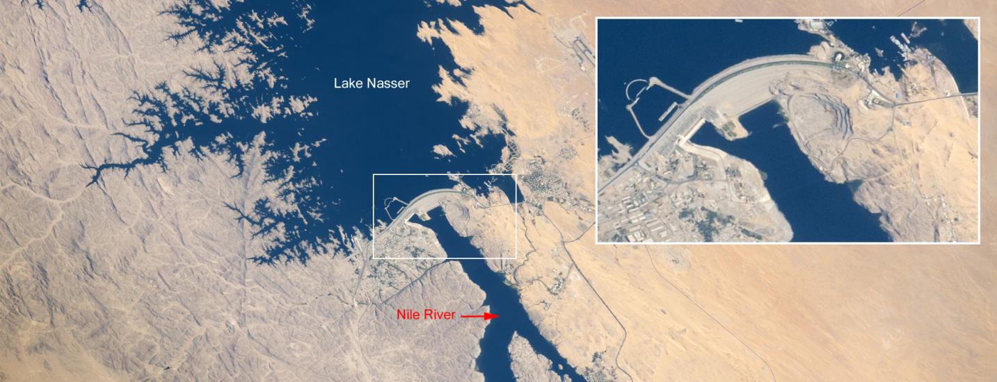 Satellite view of a lake, dam, and surrounding deserts in Egypt. A panel gives a closer perspective of the structure of the dam.