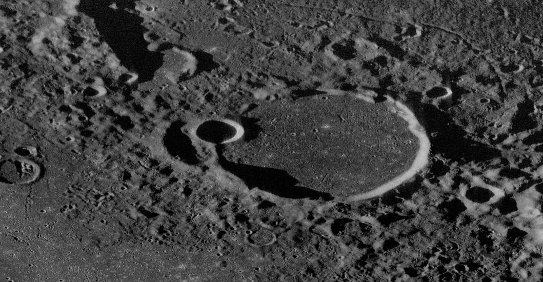 Close-up radar view of a large crater on the Moon which created a mountain-like surface in the area.