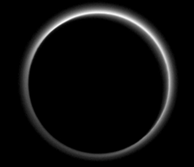 Dark side view of Pluto, a dwarf planet, with the Sun facing the other side of the dwarf planet. However, the light has created a halo-like effect on the dark side of the planet.