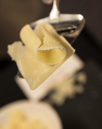 Close-up view of a slice of light yellow-colored cheese.