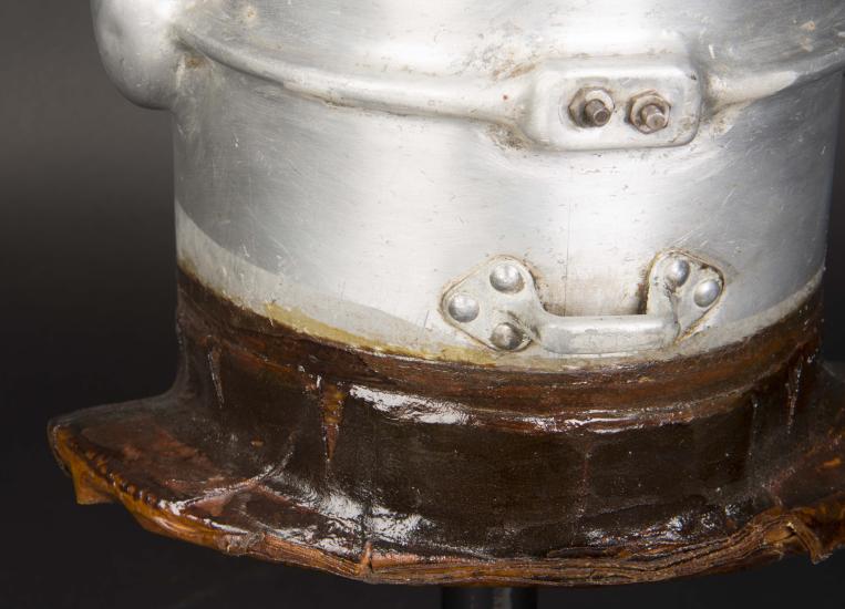 Close-up view of white-colored corrosion forming on the neck section of the first pressure suit helmet.