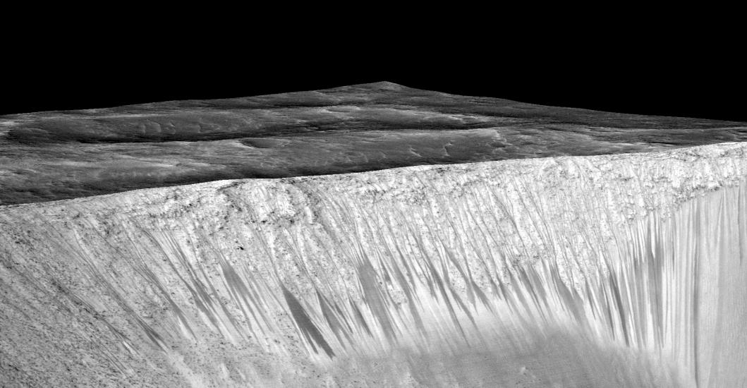 Darker-colored streak-like lines appear on the slope of a crater on Mars.