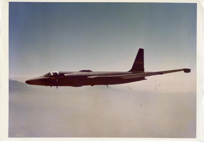 Side view of a jet aircraft with long wings. Aircraft is in flight.