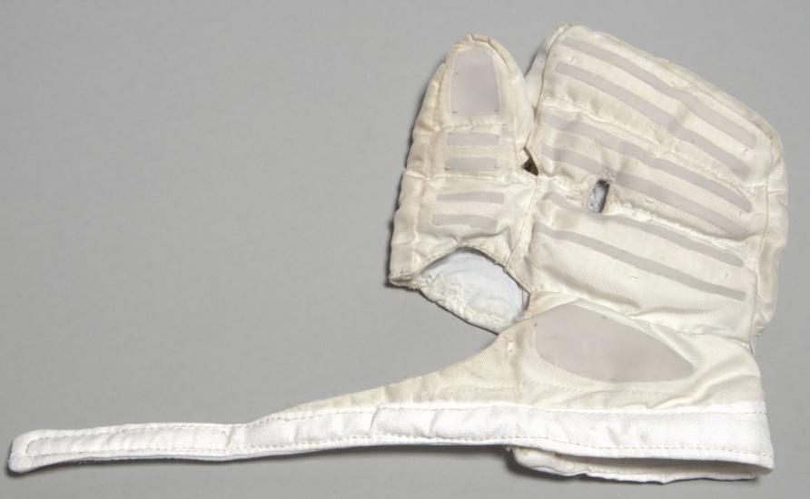 Left-handed white overglove in flat position. Part of stratospheric spacesuit.