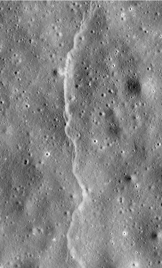 A line-shaped cliff feature is visible on a section of the Moon.