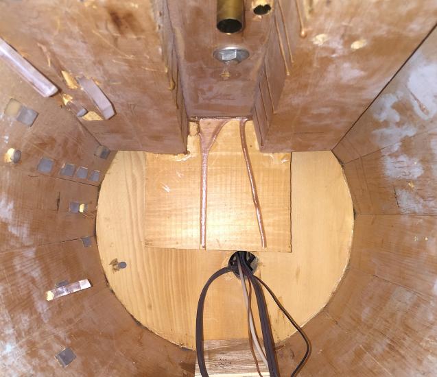 Top view of the interior of the vertical hull section of a spaceship studio model from the show Star Trek. The hull is made from light brown colored wood and plexiglass.