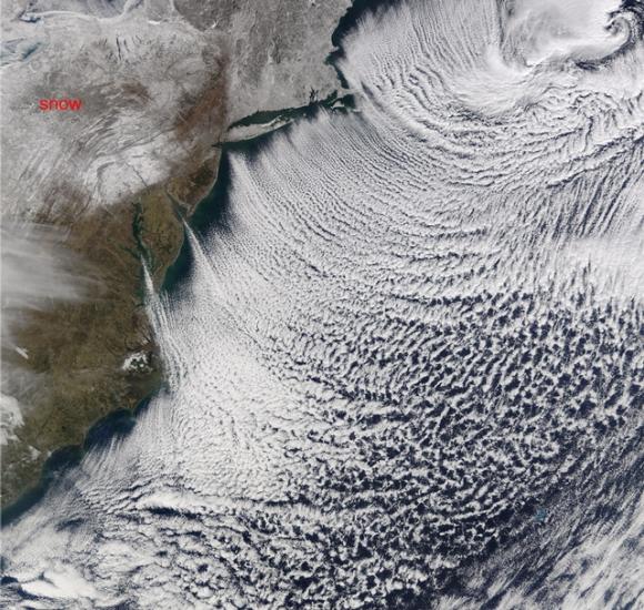 Satellite view of a group of cloud formations that look like organized rows of clouds.