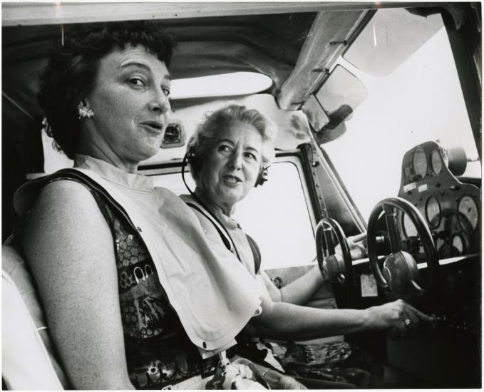 Two women, pilot Edna Whyte and her student, Martha Wright, sit in the cockpit of an aircraft during an air race.