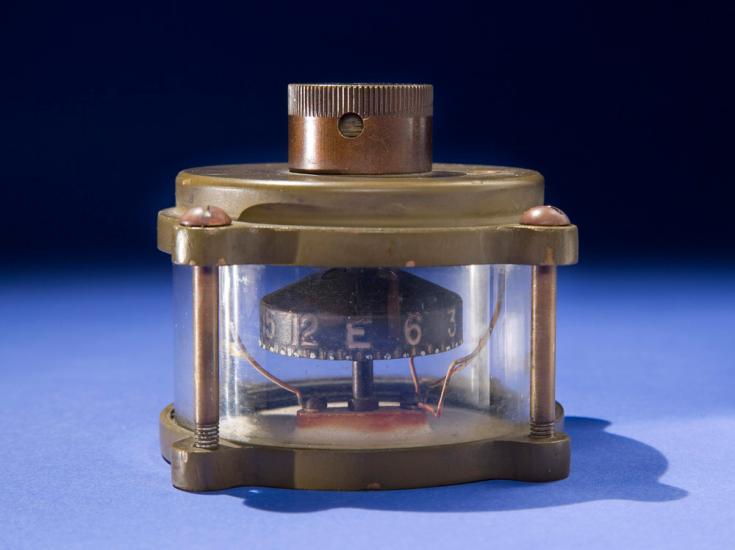 Metal and glass case containing full-rotating compass device.