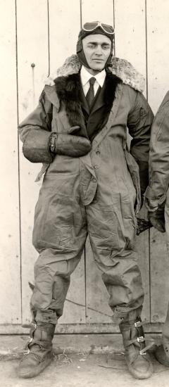 Jack Knight, a white male air mail pilot, stands informally in pilot gear.