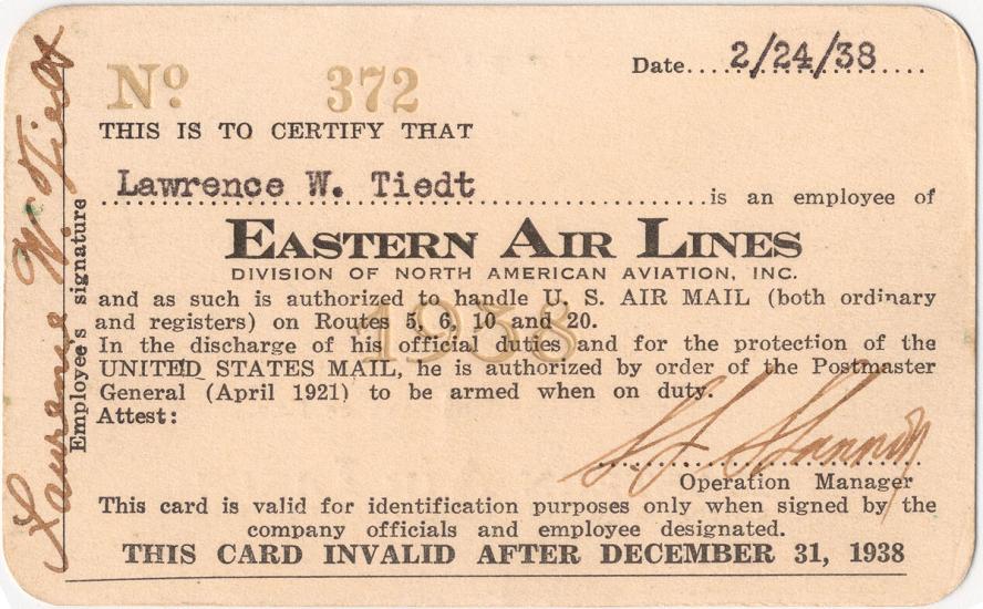 A rectangular identification card with a spot for a person's name up top and a description underneath granting the holder certain authority as related to air mail. 