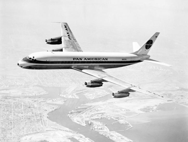 Side view of commercial aircraft with four engines and Pan American Airways livery. Aircraft is in flight.