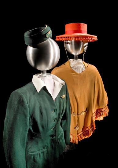 One stewardess uniform, styled on a mannequin. The uniform consists of a red sombrero and brown blouse.