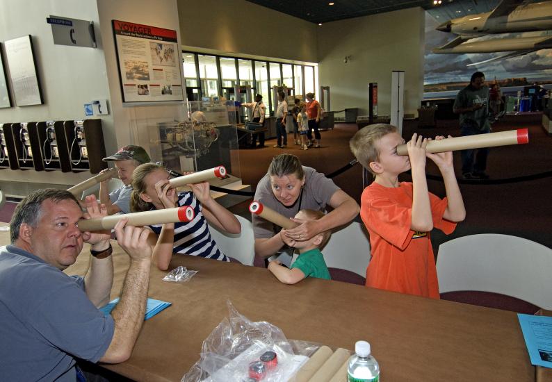 Visitors Look Through Telescopes at Explore the Universe Day