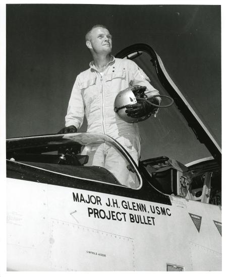 John Glenn standing in the cockpit his F8U-1P Crusader