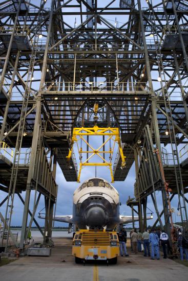 The Space Shuttle Discovery is placed under a securing device known as a mate-demate device prior to its arrival to the Udvar-Hazy Center.