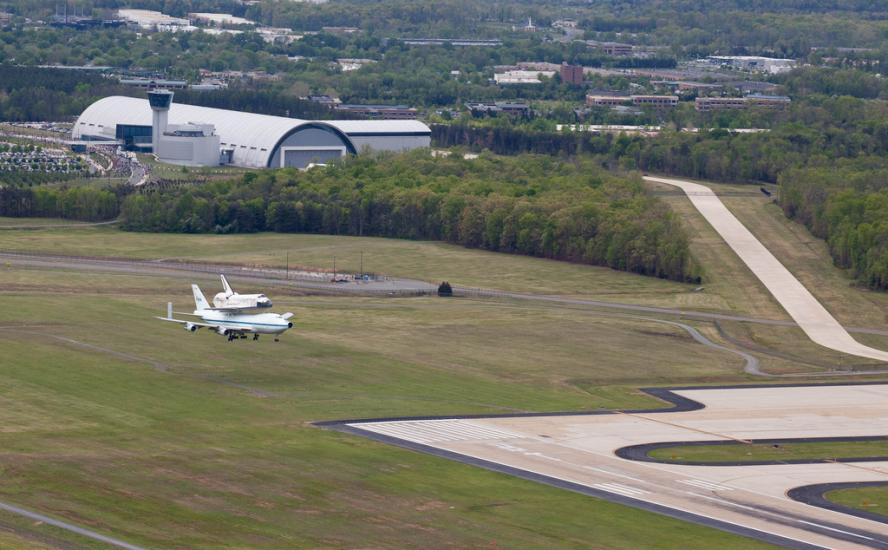 The Space Shuttle Discovery lands on a tarmac near the Udvar-Hazy Center .