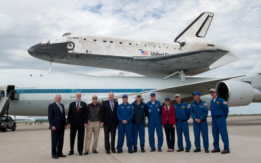 The people who transported the Space Shuttle Discovery using the Shuttle Carrier Aircraft pose for a photo following the flight.