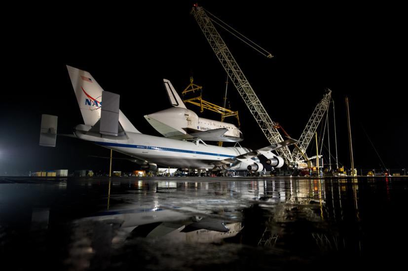 The Space Shuttle Discovery is prepared to be removed from the modified Boeing 747 used to transport the shuttle to the Udvar-Hazy Center.