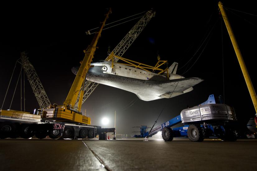 The Space Shuttle Discovery is lifted on a crane following its deattachment from the modified Boeing 747 used for shuttle transport.