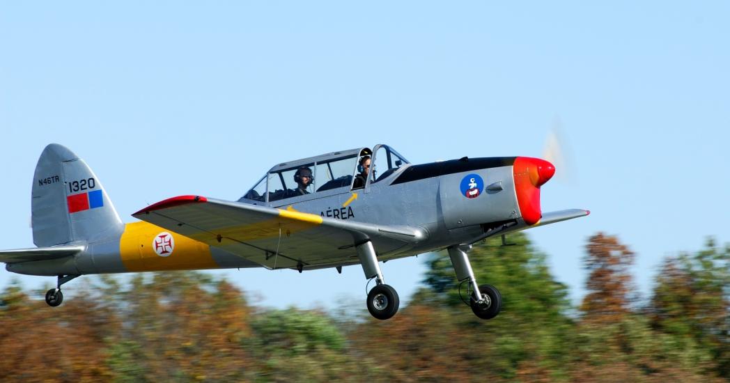 Side view of a silver and yellow aircraft with one propellor attached to the nose.