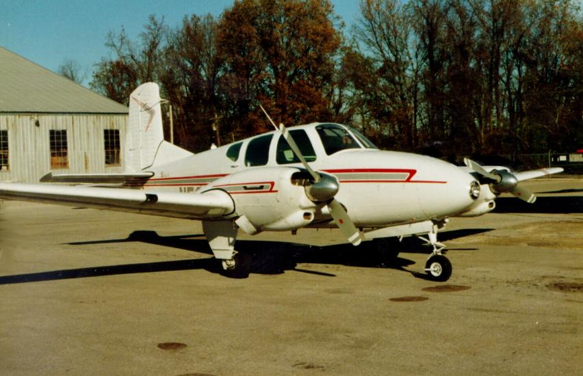 Side view of white monoplane with twin engines. 