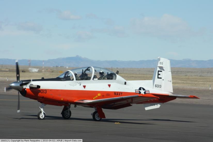 Side view of white and reddish-brown monoplane with one engine.