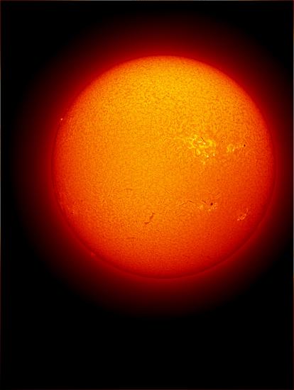 Disk view of the Sun's chromosphere with multiple sunspots visible on the surface of the Sun.