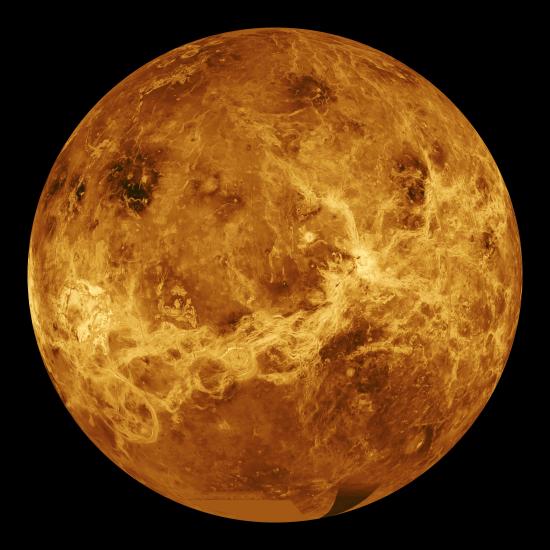 A disk view of Venus, which presents as a yellow and brown planet.