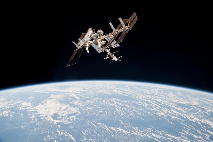 The Space Shuttle Endeavour is docked onto the International Space Station above Earth.