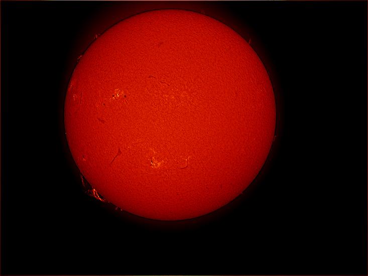 Disk view of the Sun featuring a prominence of floating gas above the lower half of the Sun. Phages are indicated by lighter colors and are visible mostly on the left half.