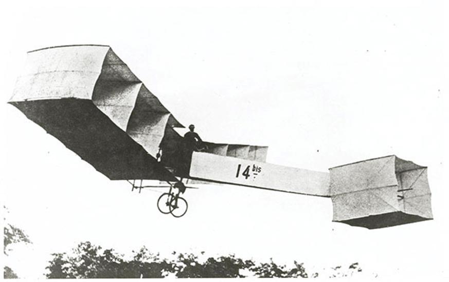 A person flies an early biplane with multiple box-like shapes forming the wings and nose.