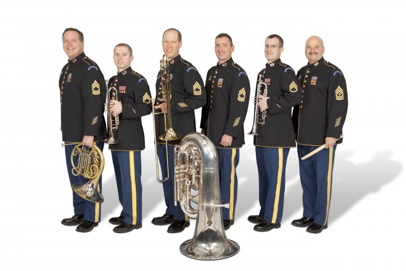 A group of six people holding various brass instruments.