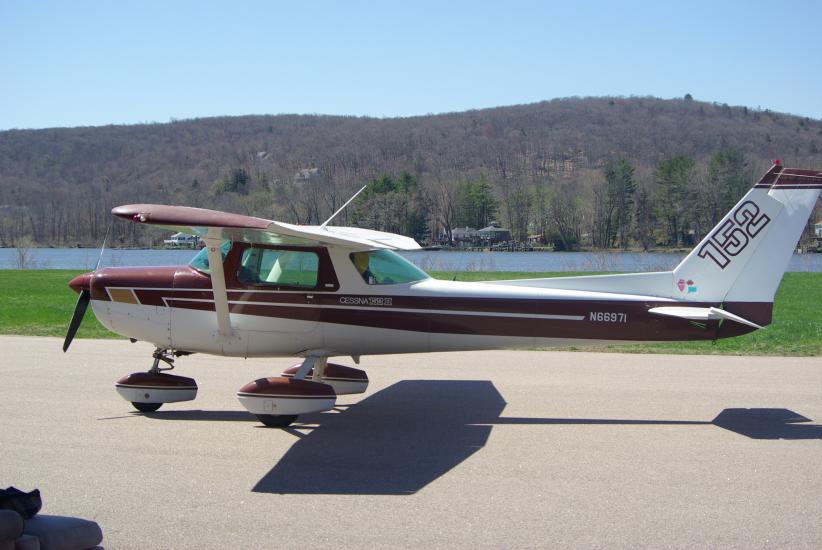 Red and white monoplane with single engine and fixed landing gear.