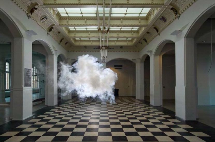 Artwork featuring a white cloud inside a building with a large floor.