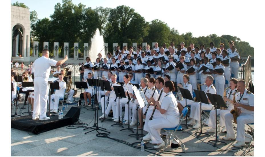 United States Public Health Service Music Ensemble, a large group of musicians, performs in a concert.